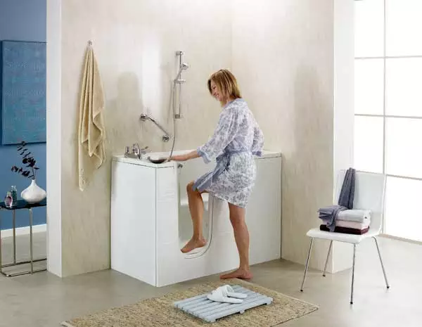 bath with door lady stepping in low entry bath