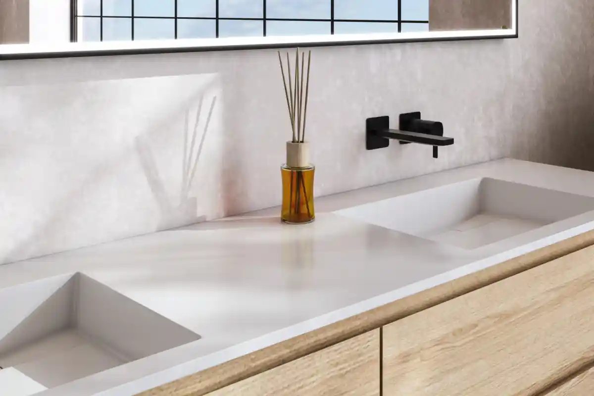 A bathroom sink with a vase of flowers on top of it