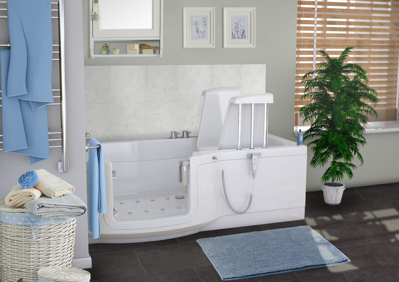 Walk-in bath with powered seat lift, clear side door, and handheld shower, placed in modern bathroom with towel rail and accessories.