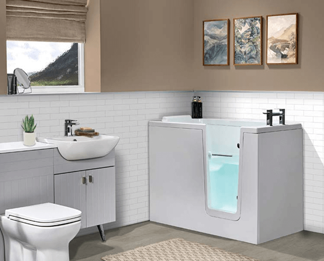 White walk-in bath with clear side door and built-in seat, next to sink vanity and toilet in a modern, accessible bathroom.