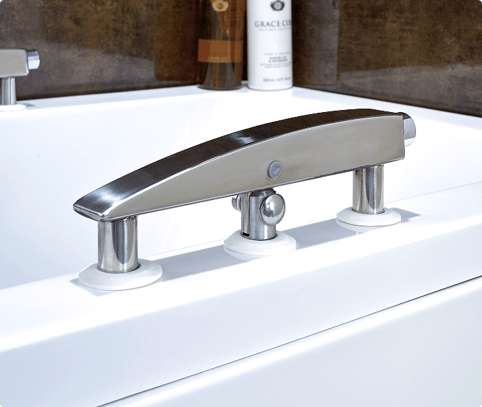 This is the Leyburn bath filler, a sleek and modern tap designed to complement the Leyburn walk-in bath. It features a polished stainless steel finish with a smooth, curved design. The filler is mounted on three sturdy supports and includes a central control knob for easy operation. Its elegant design enhances both the functionality and aesthetics of the Leyburn bath setup.