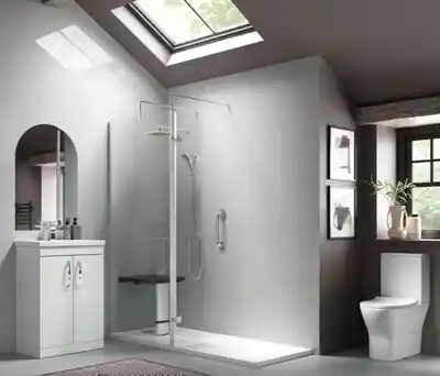 Contemporary bathroom featuring a Richmond full-height single panel shower screen beneath a skylight, with walk-in enclosure, white vanity unit and compact toilet.