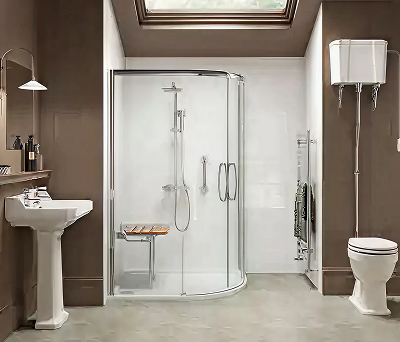 Richmond rimless offset quadrant shower in a traditional bathroom setting, featuring a curved glass enclosure, fold-down wooden seat and high-level toilet.