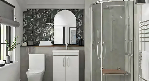 Modern bathroom with a Richmond rimless sliding quadrant cubicle, shown alongside a corner toilet and minimalist vanity unit beneath a curved mirror.